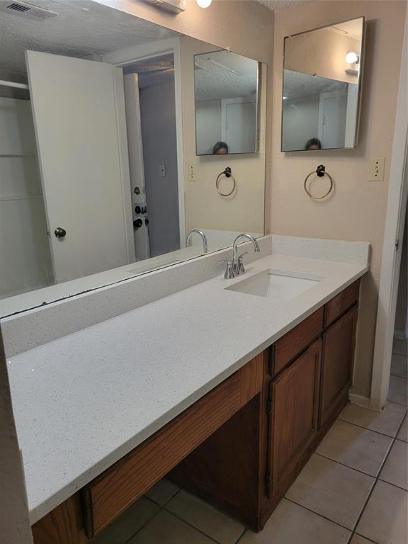 9601 Walnut Street, Unit 5103 Dallas, TX 75243 - Photo 3 of 6 a bathroom with a sink and a mirror