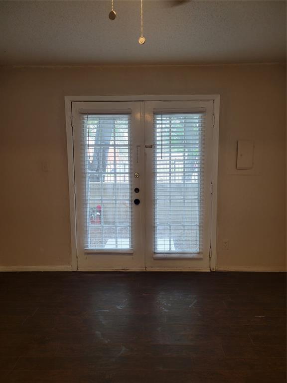 9601 Walnut Street, Unit 5103 Dallas, TX 75243 - Photo 5 of 6 a view of wooden floor and windows in an empty room