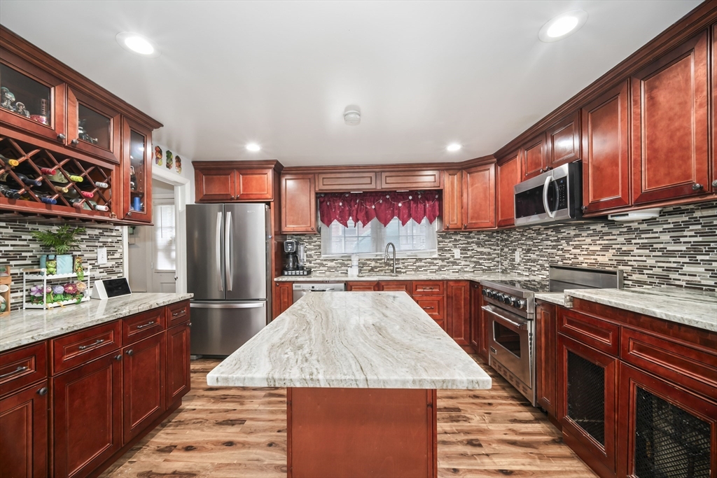 5 Debbie Road Brockton, MA 02302 - Photo 17 of 30 a kitchen with stainless steel appliances granite countertop a refrigerator and a stove top oven