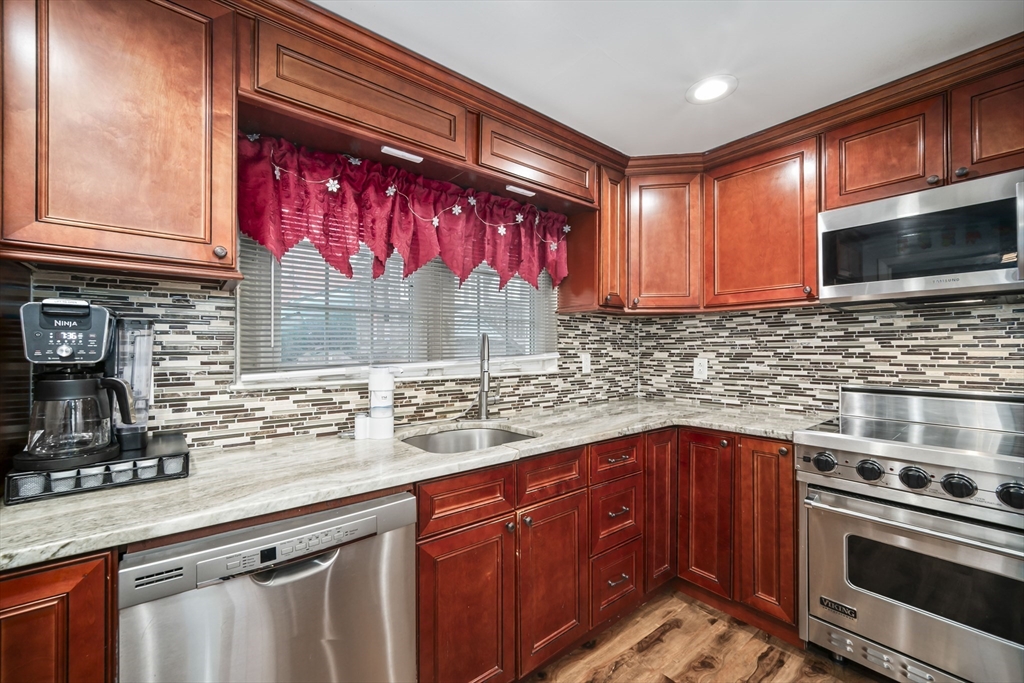 5 Debbie Road Brockton, MA 02302 - Photo 18 of 30 a kitchen with stainless steel appliances wooden cabinets a stove and a sink