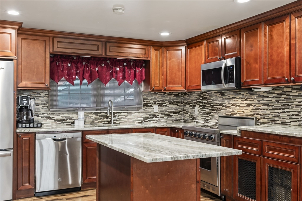 5 Debbie Road Brockton, MA 02302 - Photo 19 of 30 a kitchen with stainless steel appliances granite countertop a sink stove and microwave