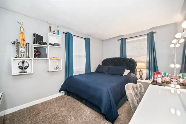 a bedroom with a bed and a large mirror