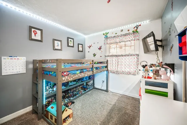 a bedroom with a bed and a tv