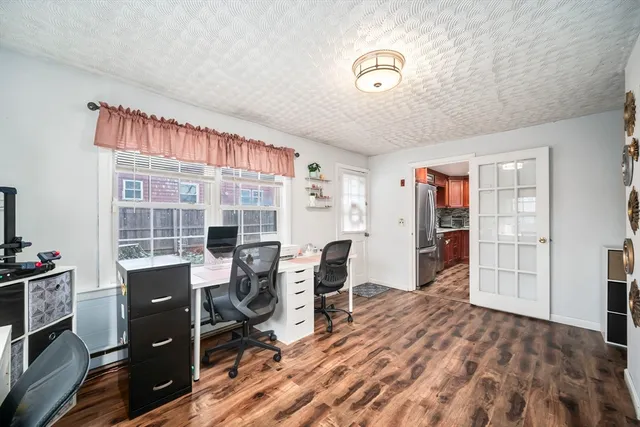 a view of a workspace with furniture and a window