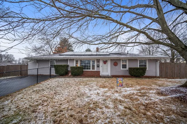 a house that has a tree in front of it