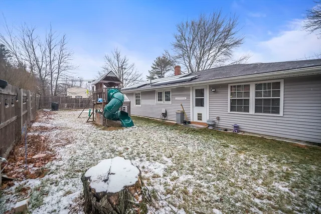a backyard of a house with table and chairs