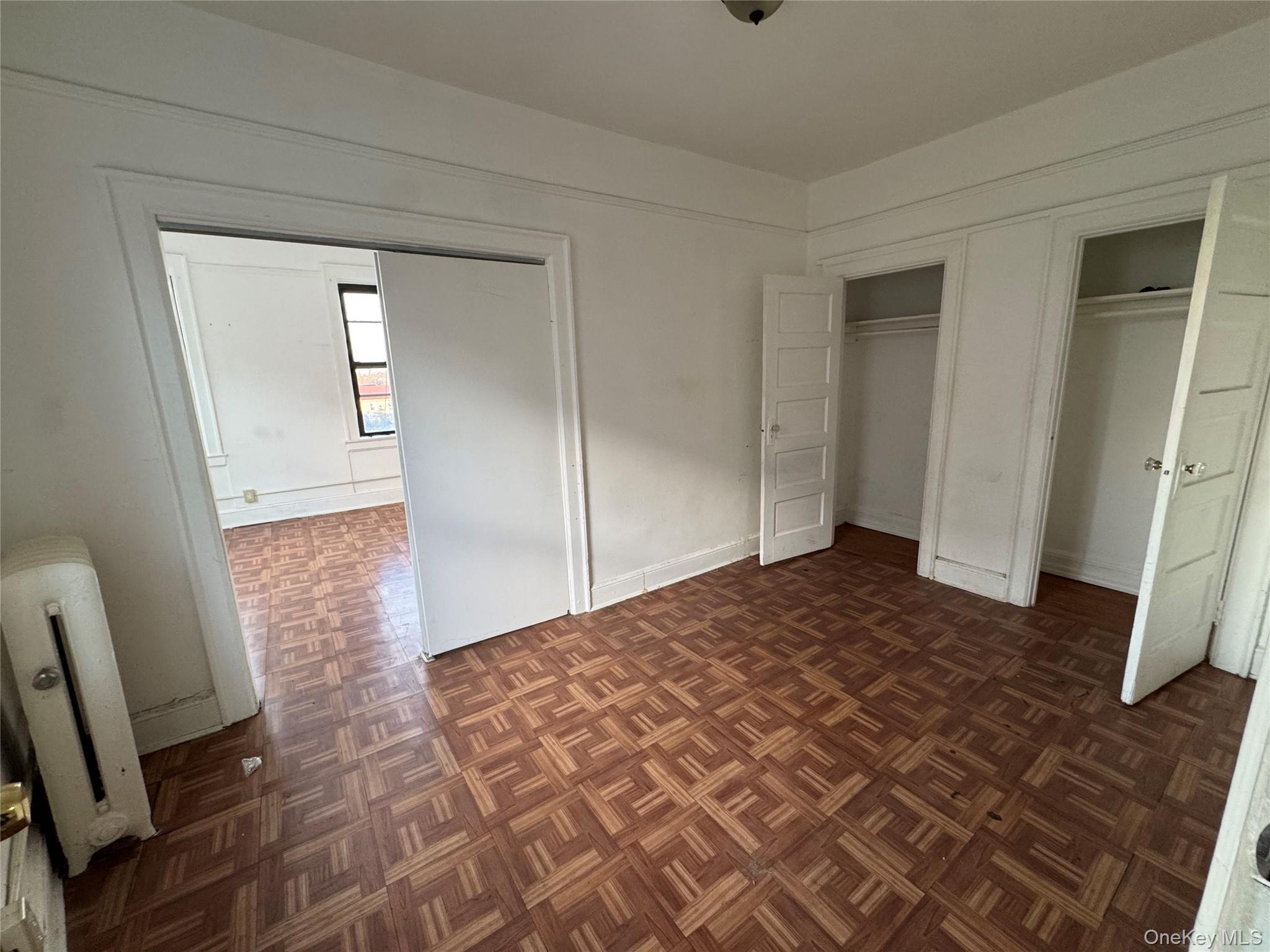 3307 Junction Boulevard, Unit 3 Queens, NY 11372 - Photo 2 of 8 a bedroom with a bed and wooden floor