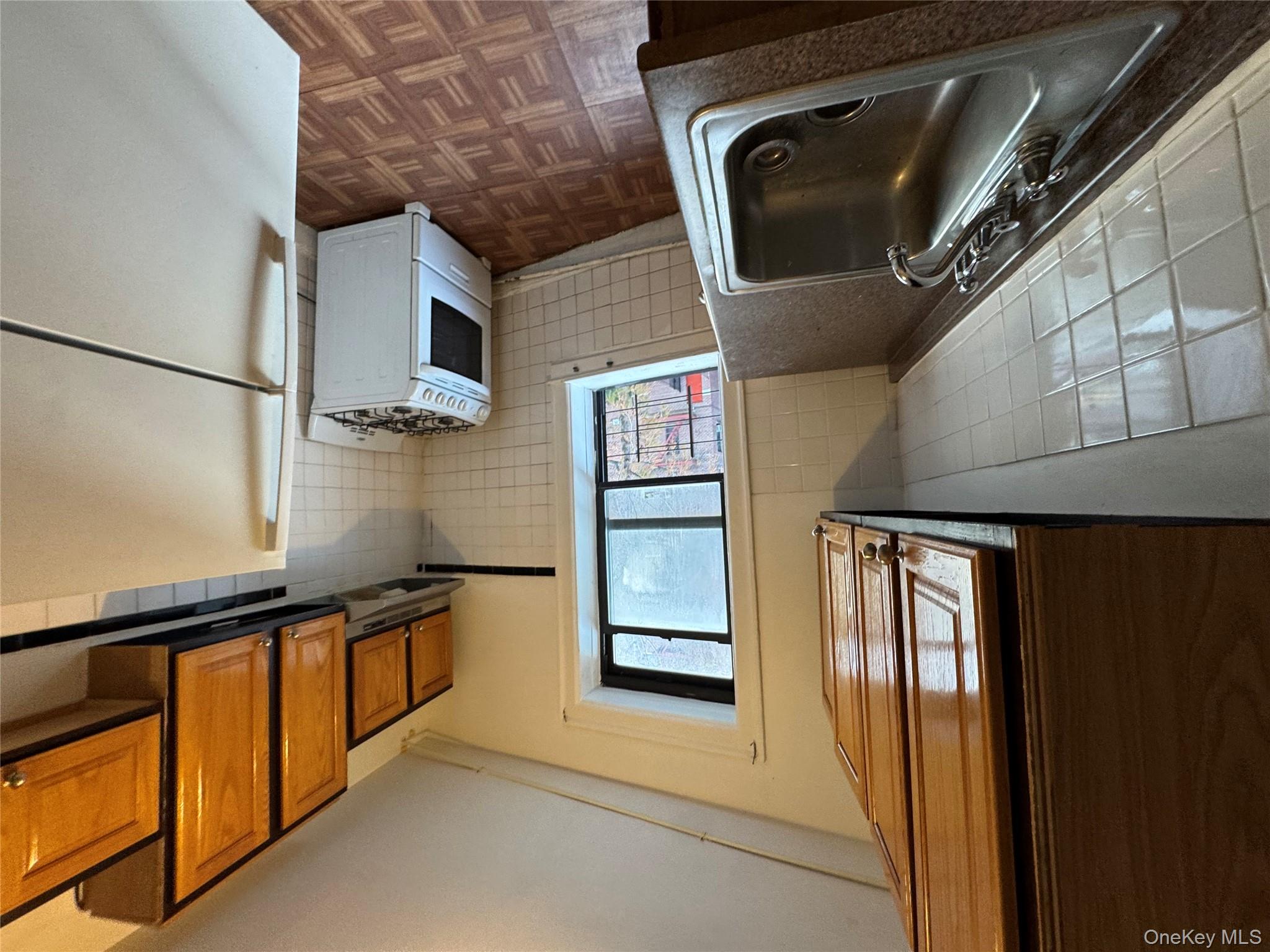 3307 Junction Boulevard, Unit 3 Queens, NY 11372 - Photo 6 of 8 a kitchen with a refrigerator and a sink