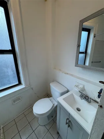 a bathroom with a sink mirror and toilet