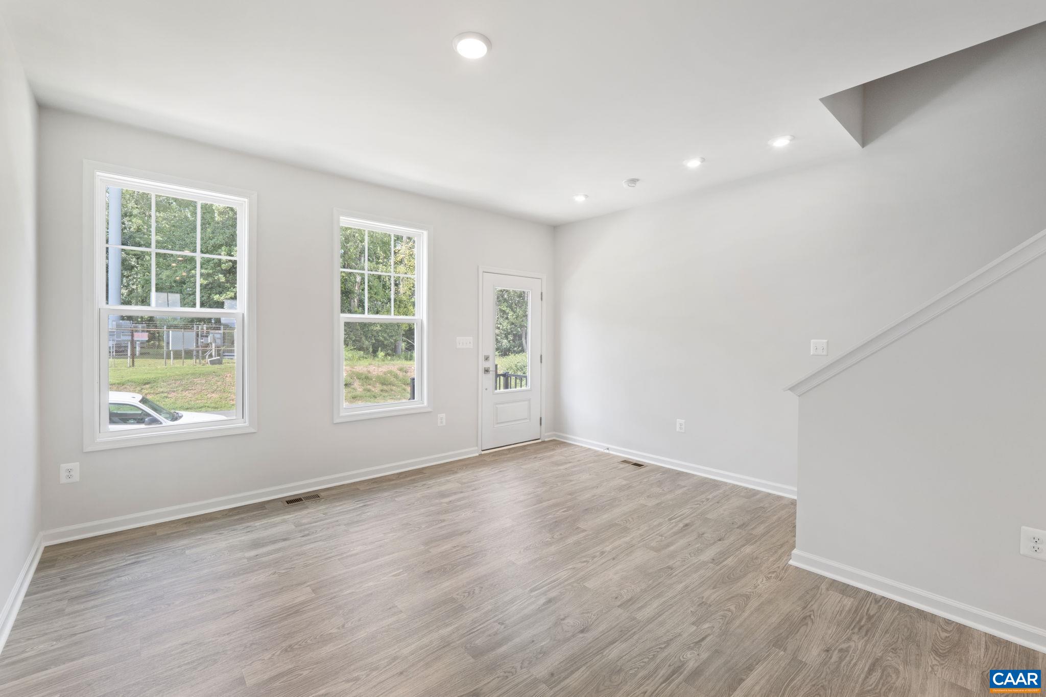 2243 Woodburn Road Charlottesville, VA 22901 - Photo 23 of 53 an empty room with wooden floor and windows