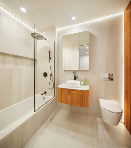a bathroom with a tub toilet sink shower and mirror