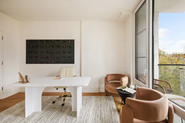 a living room with furniture a window and a flat screen tv