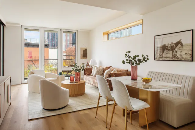 a dining room with furniture and wooden floor