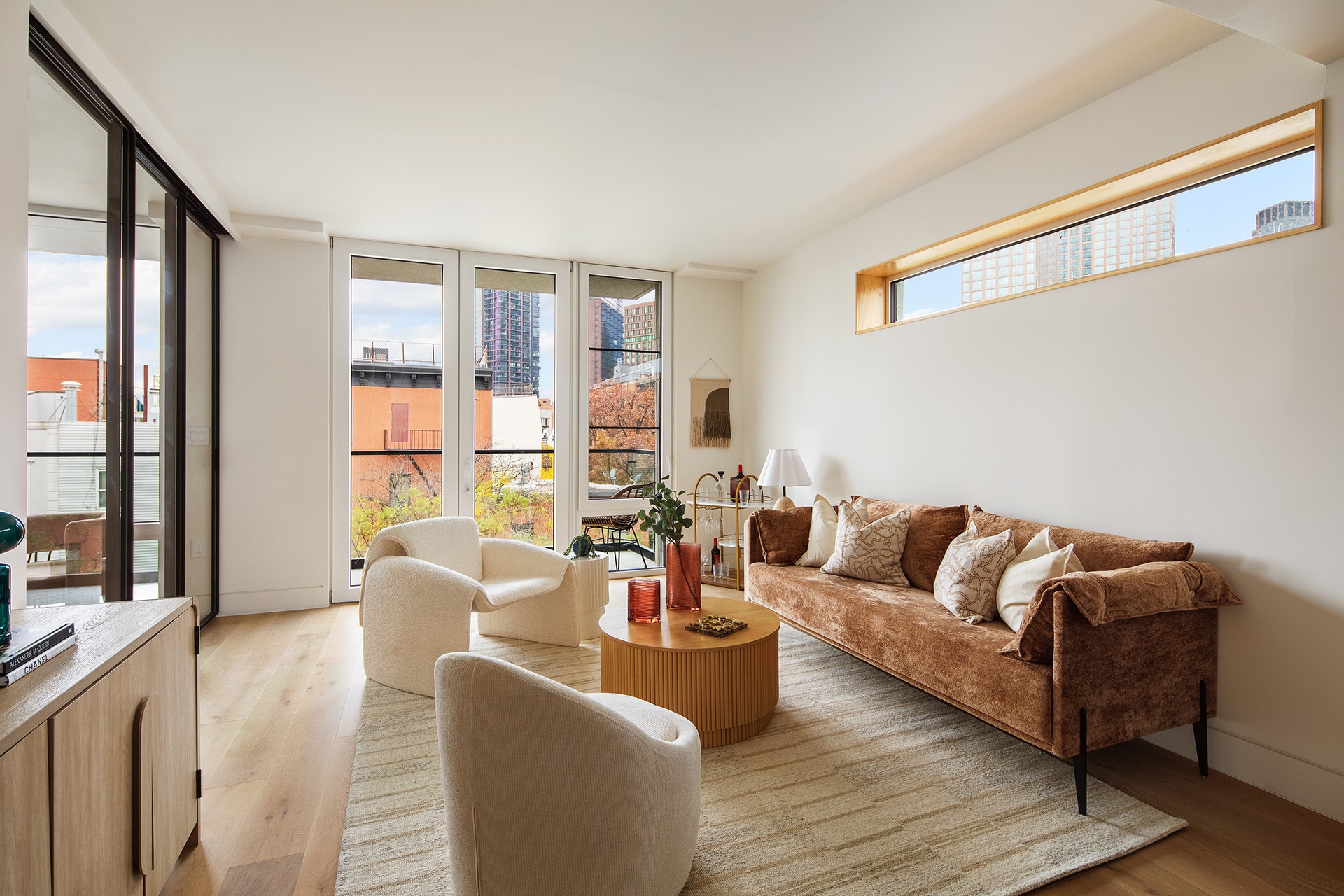 1110 Manhattan Avenue, Unit PH Brooklyn, NY 11222 - Photo 6 of 16 a living room with furniture and a large window