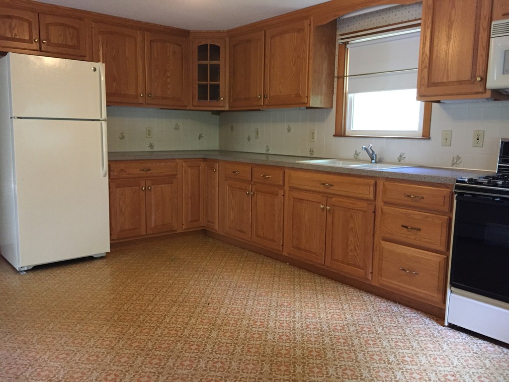 33 Robinwood Road Wareham, MA 02532 - Photo 5 of 13 a kitchen with sink a refrigerator and cabinets