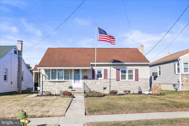 a view of a white house with a swimming pool