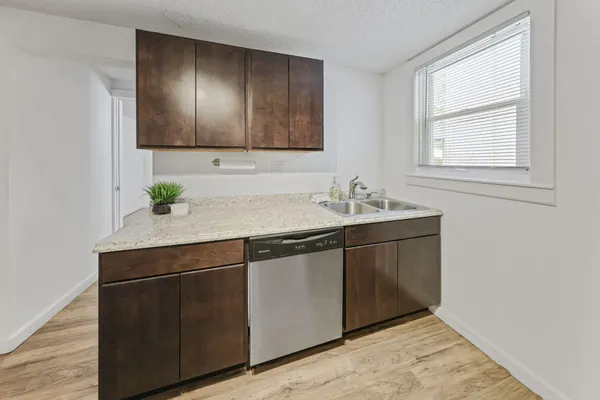 a sink with wooden cabinets