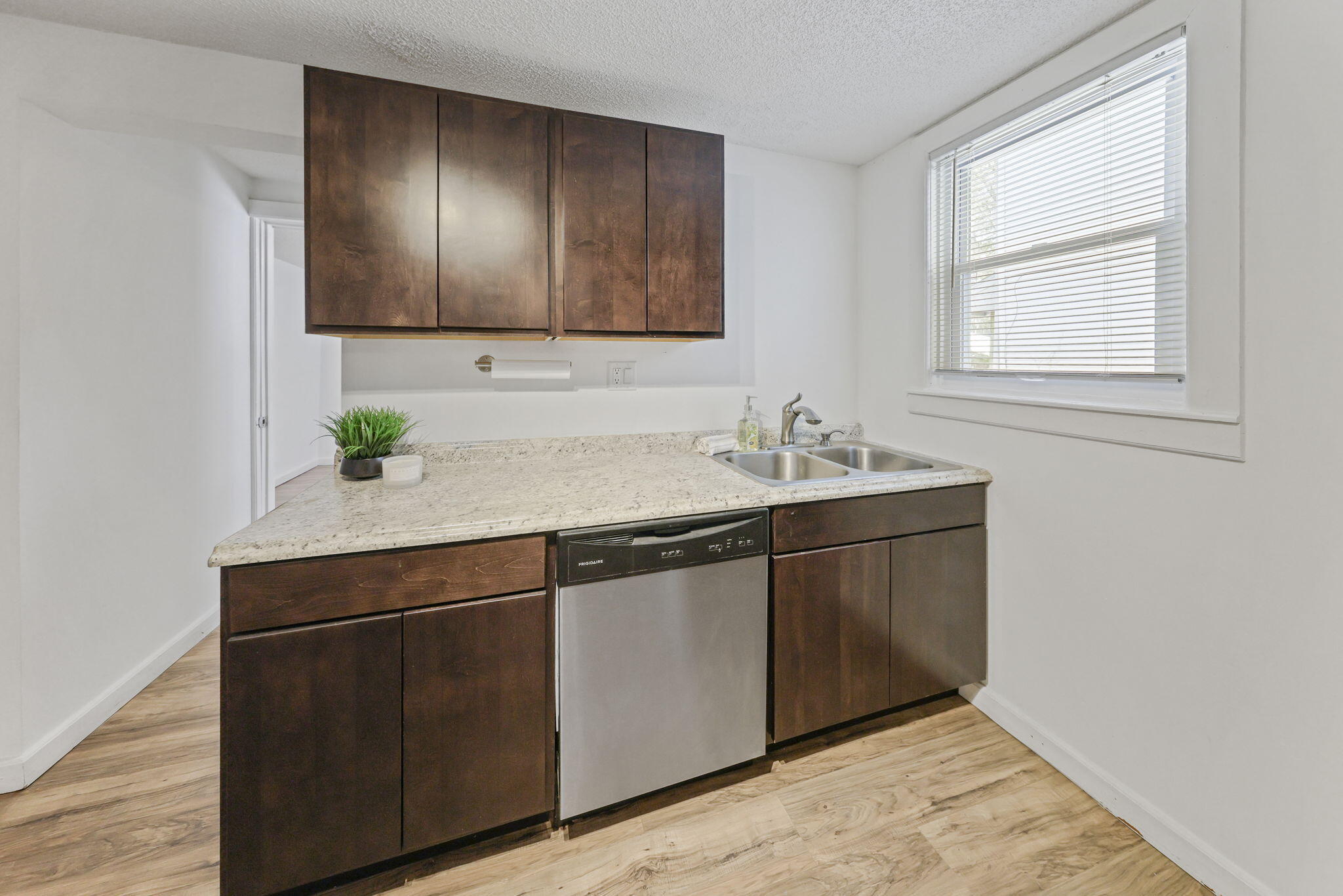 361 Locust Street, Unit 4 Valparaiso, IN 46383 - Photo 4 of 10 a sink with wooden cabinets