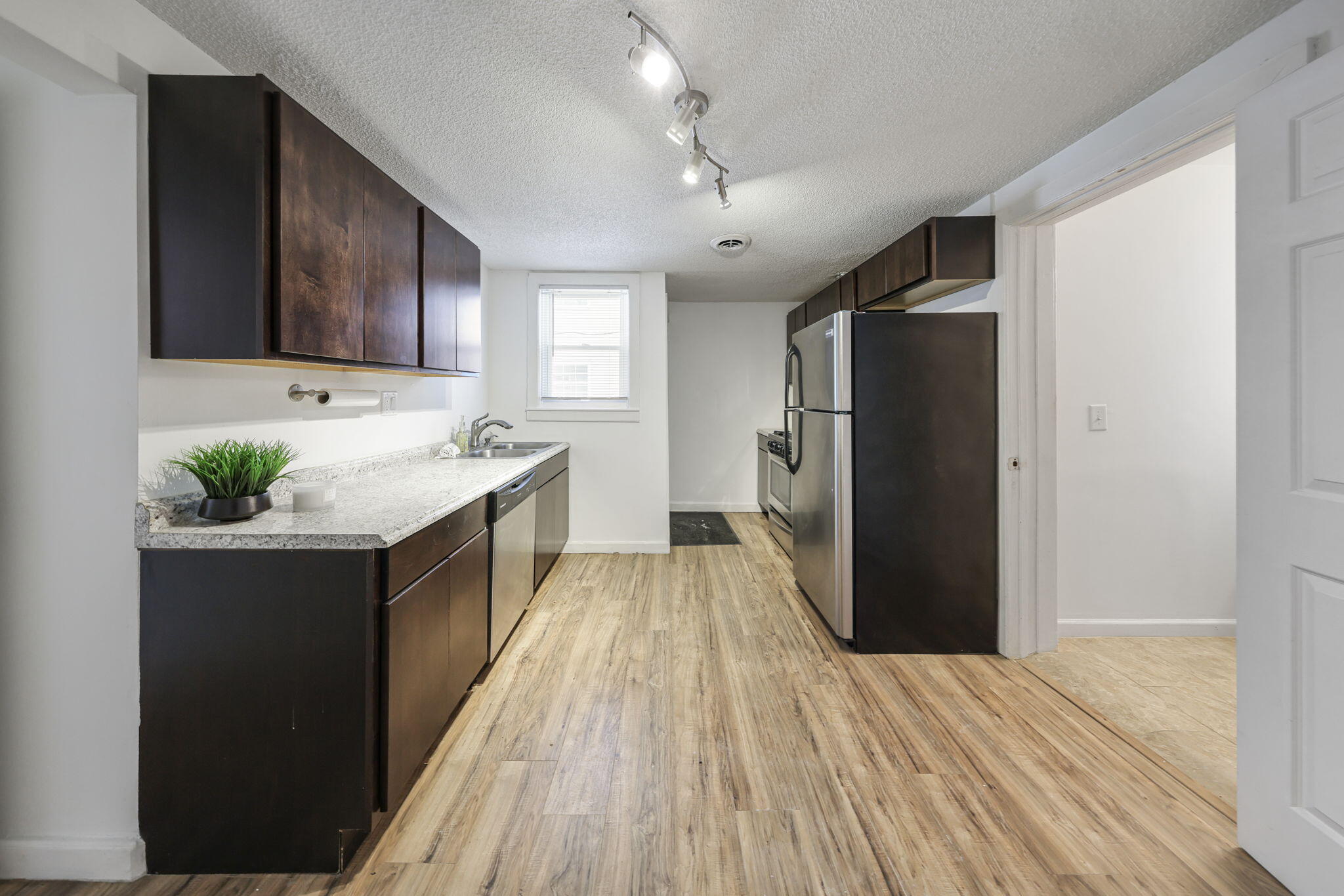 361 Locust Street, Unit 4 Valparaiso, IN 46383 - Photo 5 of 10 a kitchen with a sink and wooden cabinets