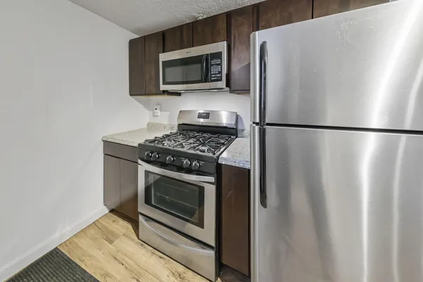 a kitchen with a refrigerator stove and microwave