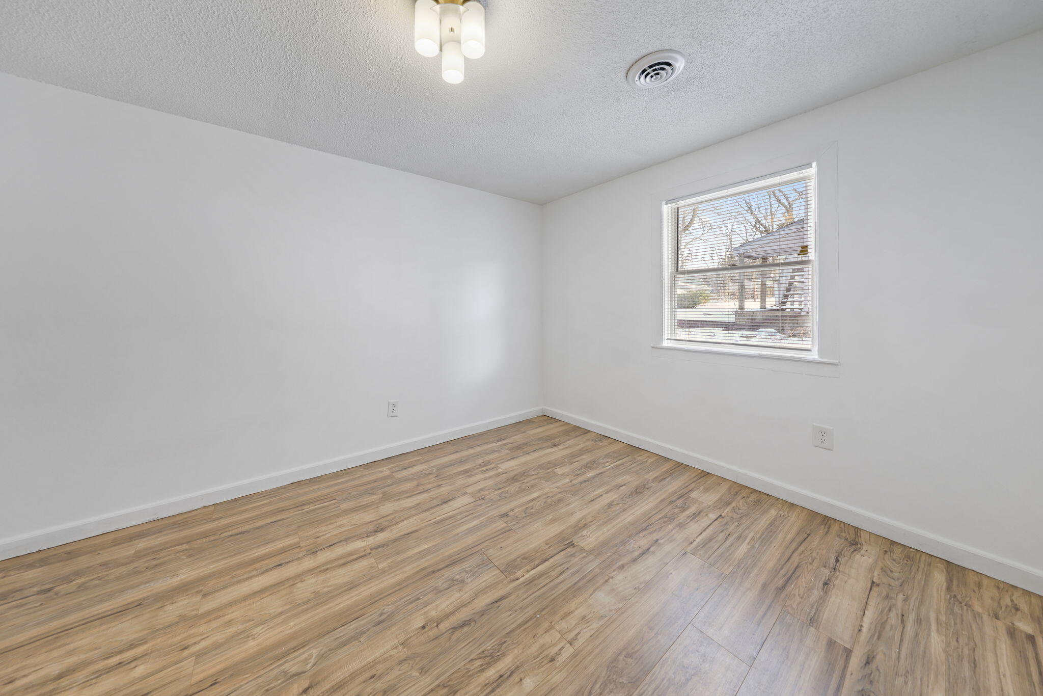 361 Locust Street, Unit 4 Valparaiso, IN 46383 - Photo 7 of 10 a view of an empty room with wooden floor and a window