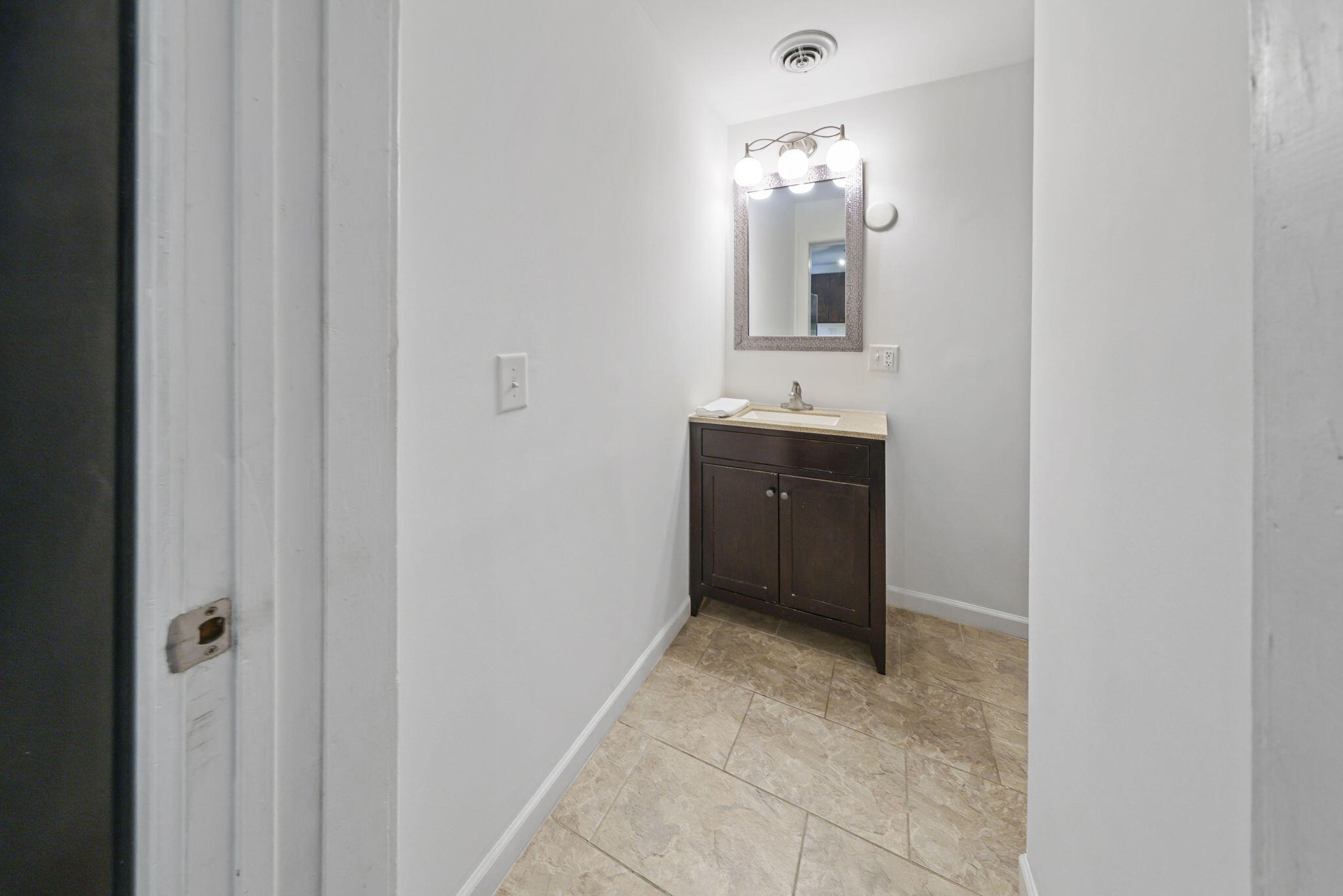 361 Locust Street, Unit 4 Valparaiso, IN 46383 - Photo 9 of 10 a bathroom with a sink and a mirror