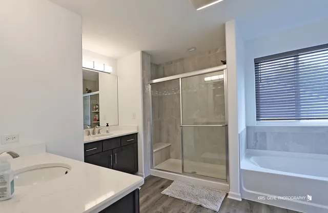 a bathroom with a sink a bathtub and a shower