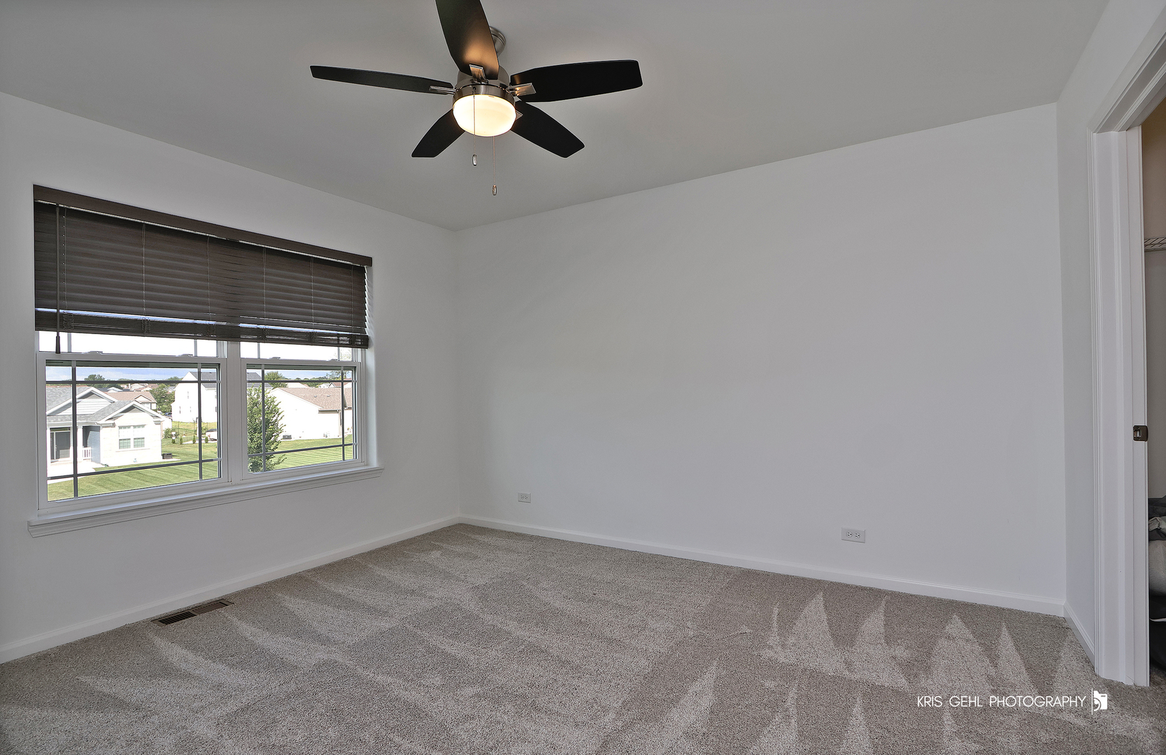 10718 Hunt Club Road Richmond, IL 60071 - Photo 20 of 28 an empty room with a window and a ceiling fan
