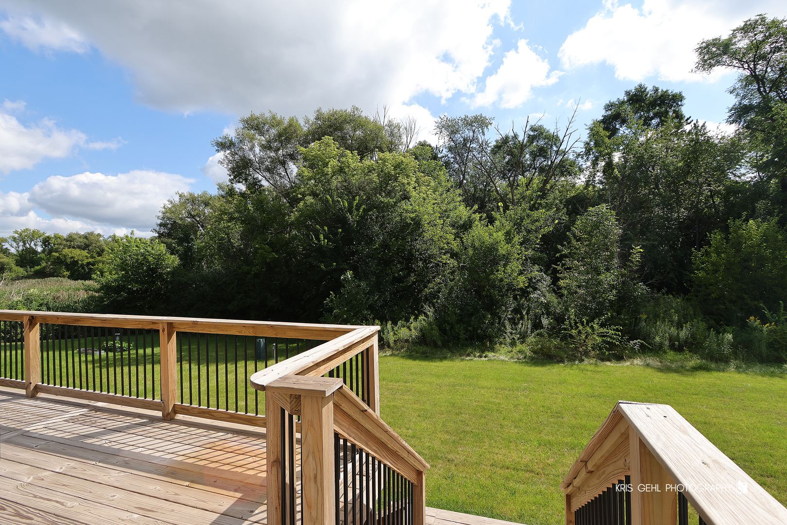 10718 Hunt Club Road Richmond, IL 60071 - Photo 24 of 28 a view of a wooden deck with a big yard
