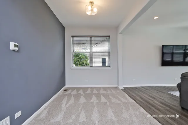 a view of a livingroom with wooden floor and window