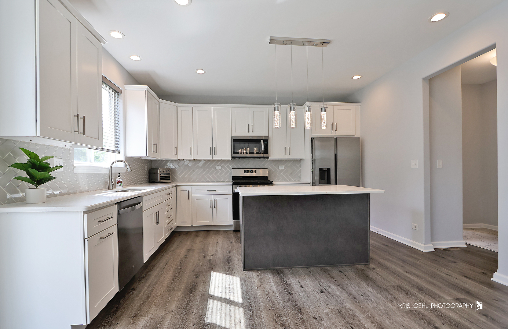 10718 Hunt Club Road Richmond, IL 60071 - Photo 8 of 28 a kitchen with kitchen island granite countertop a sink cabinets and wooden floor