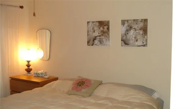 a bedroom with a bed and a mirror