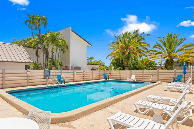 a view of a backyard with plants and swimming pool