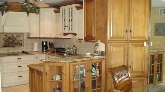 a kitchen with stainless steel appliances granite countertop a sink a stove and white cabinets