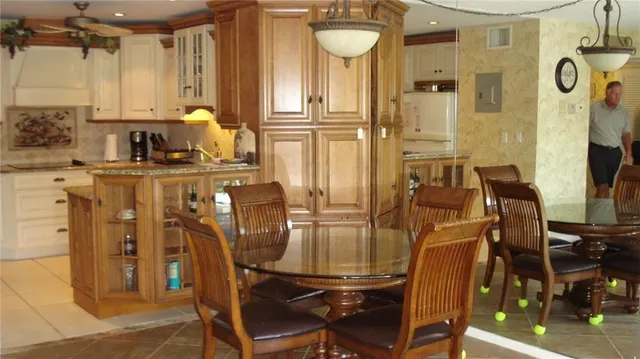 a kitchen with a refrigerator a stove a sink and cabinets