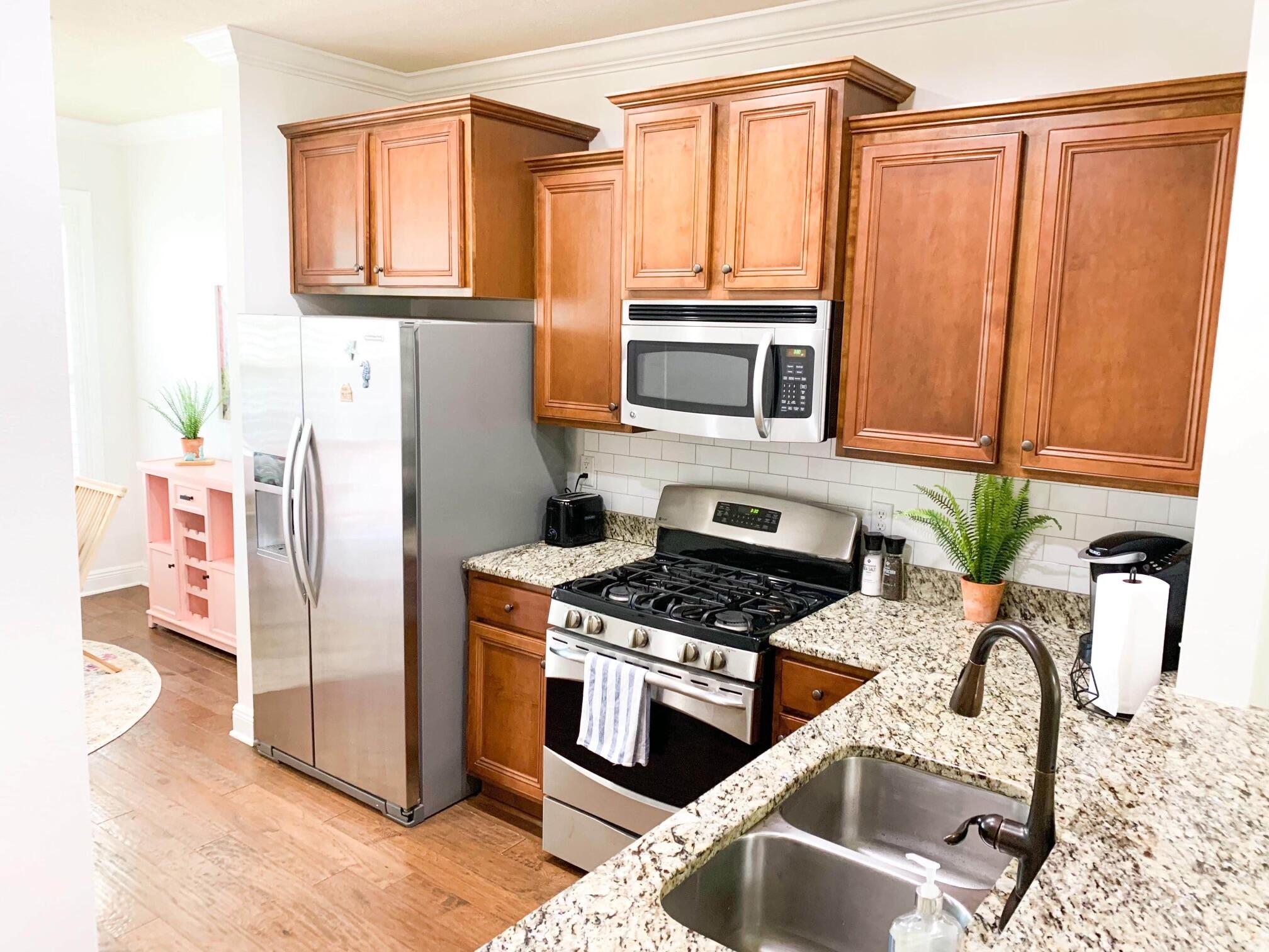 184 Golf Villa Drive Santa Rosa Beach, FL 32459 - Photo 10 of 24 a kitchen with granite countertop a refrigerator stove and microwave