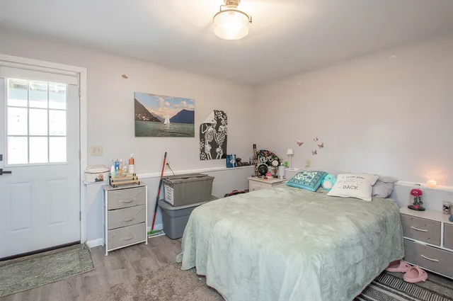 a bedroom with a bed and a desk