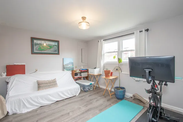a bedroom with furniture and a wooden floor