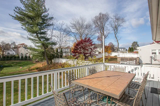 a view of a balcony with wooden floor and fence