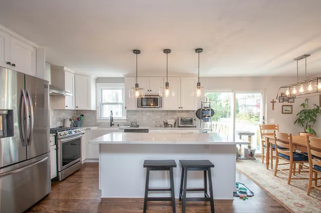 a kitchen with appliances a sink and cabinets