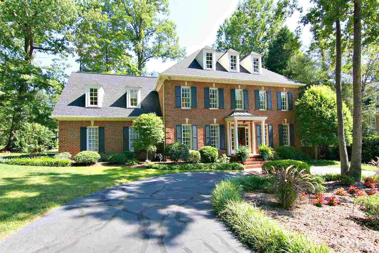 601 Chalfant Court Raleigh, NC 27607 - Photo 1 of 24 a front view of a house with garden and trees