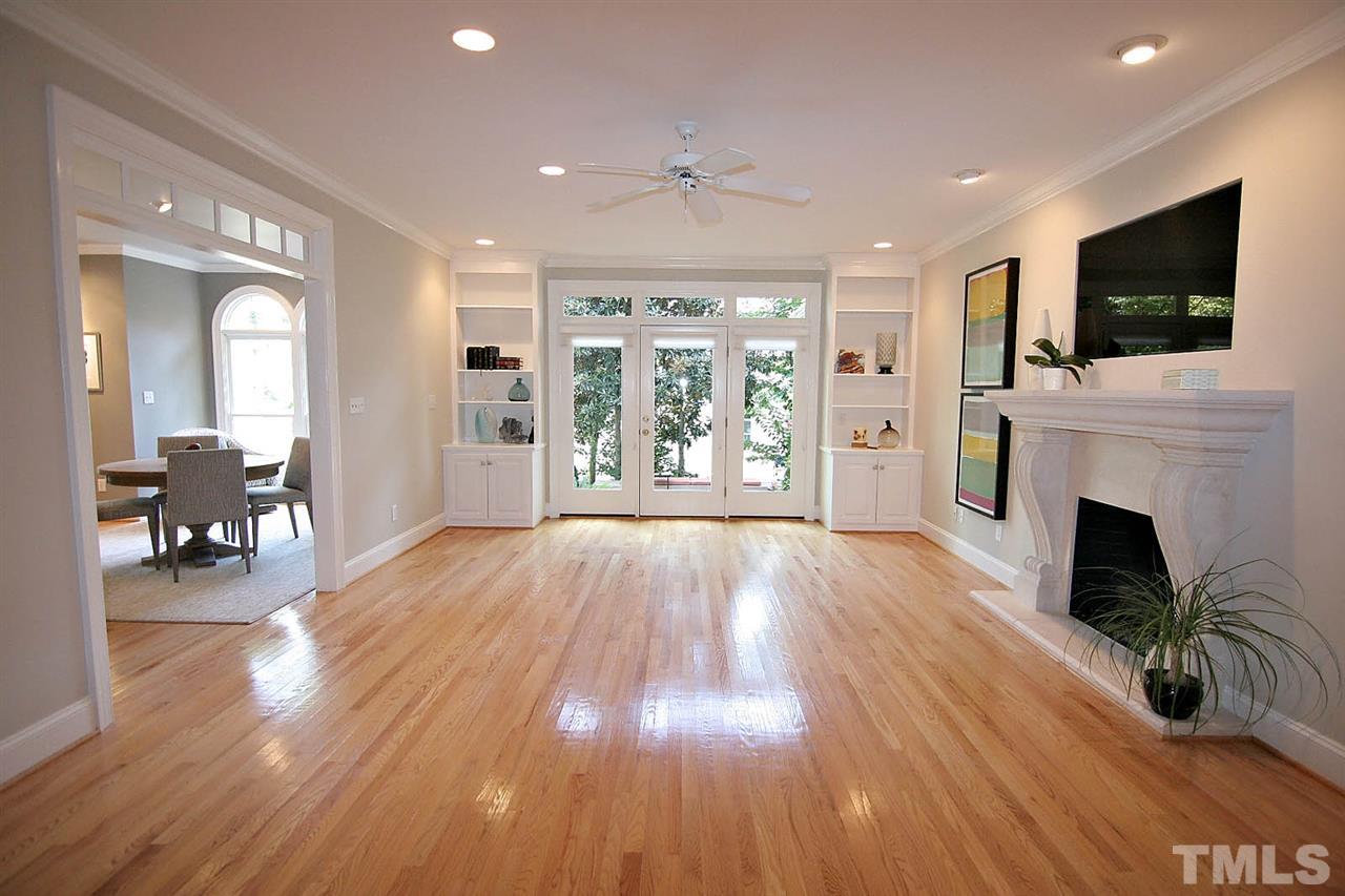 601 Chalfant Court Raleigh, NC 27607 - Photo 14 of 24 a view of livingroom with fireplace dining room and wooden floor
