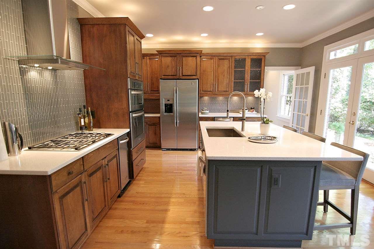 601 Chalfant Court Raleigh, NC 27607 - Photo 18 of 24 a kitchen with kitchen island granite countertop a sink and a stove