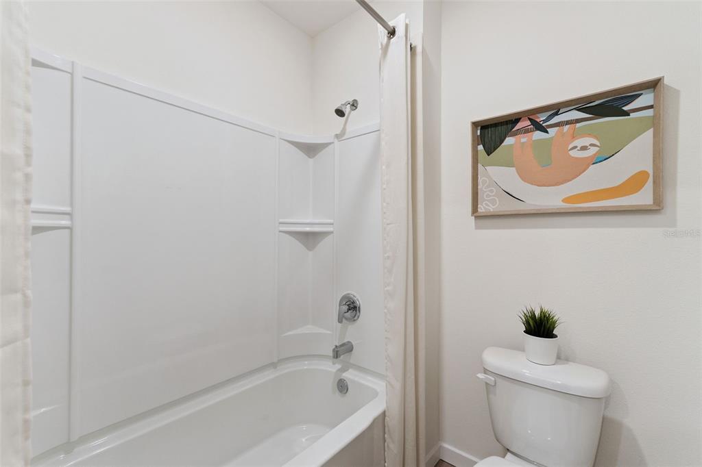 2833 House Finch Road St. Cloud, FL 34773 - Photo 30 of 70 a bath room with a toilet and a bath tub
