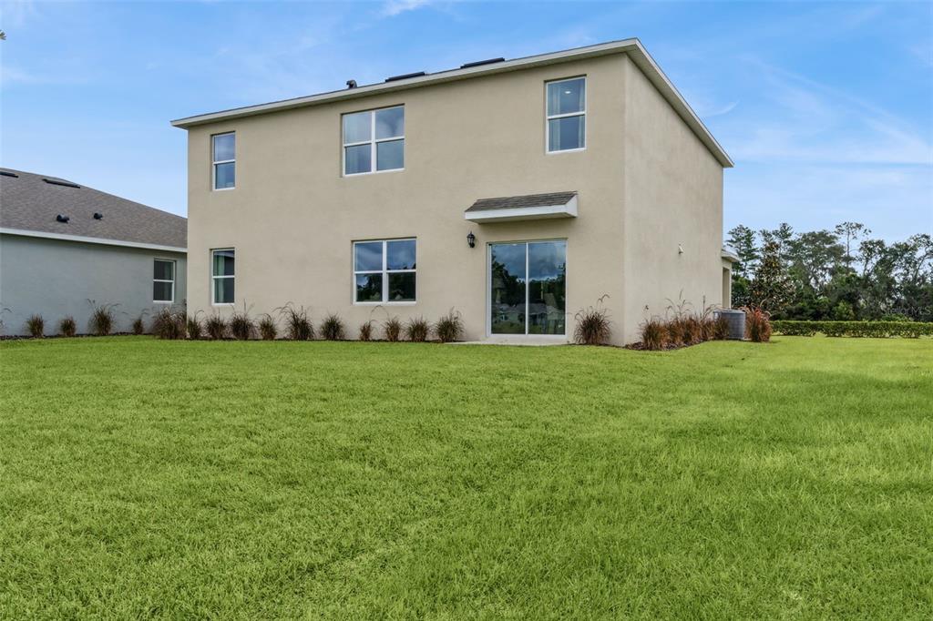 2833 House Finch Road St. Cloud, FL 34773 - Photo 33 of 70 a front view of house with yard and green space