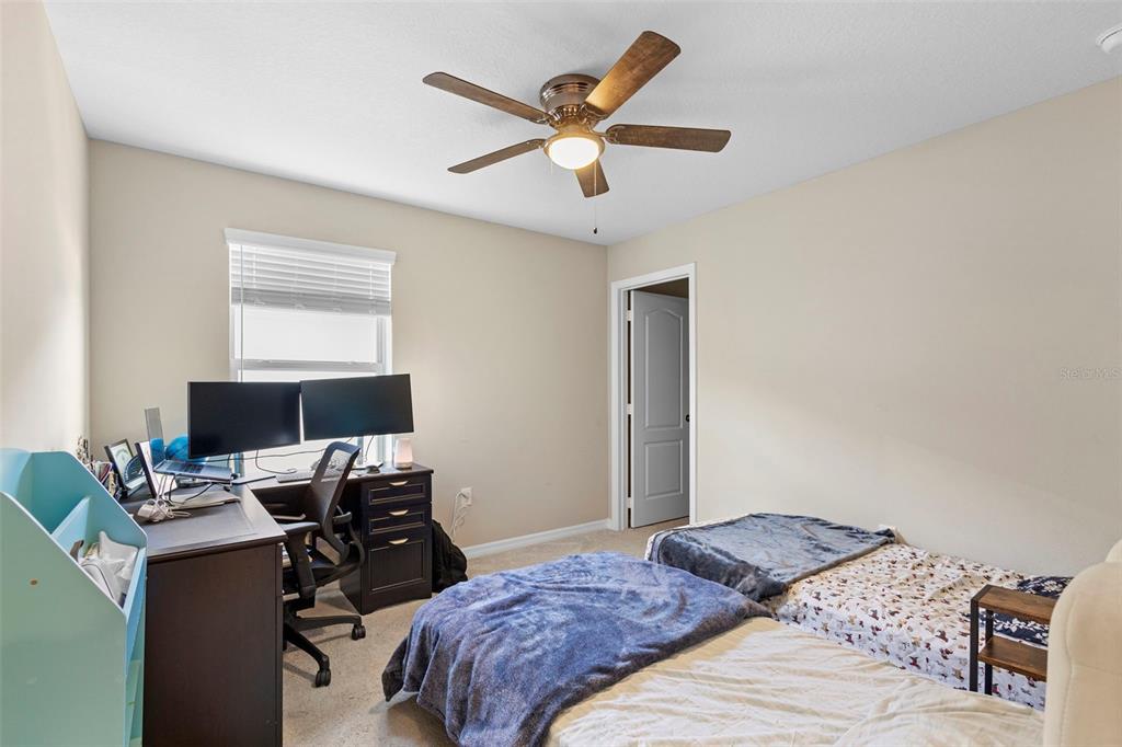 3937 Ceremony Cove Sanford, FL 32771 - Photo 15 of 51 a bedroom that has a bed and a desk in it