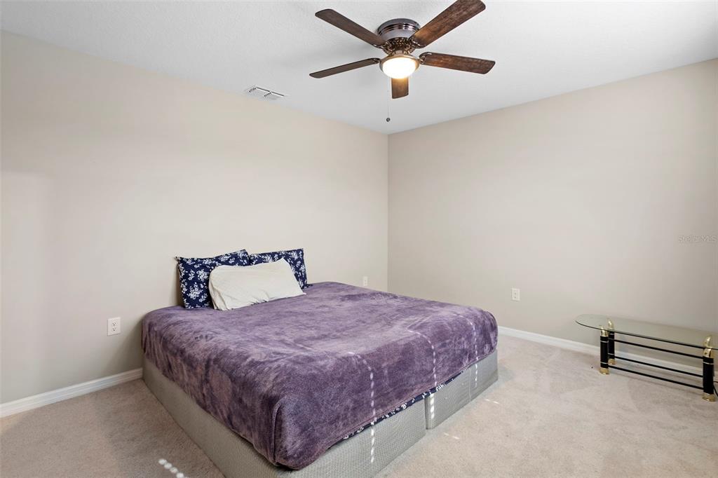 3937 Ceremony Cove Sanford, FL 32771 - Photo 29 of 51 a bedroom with a bed and a ceiling fan