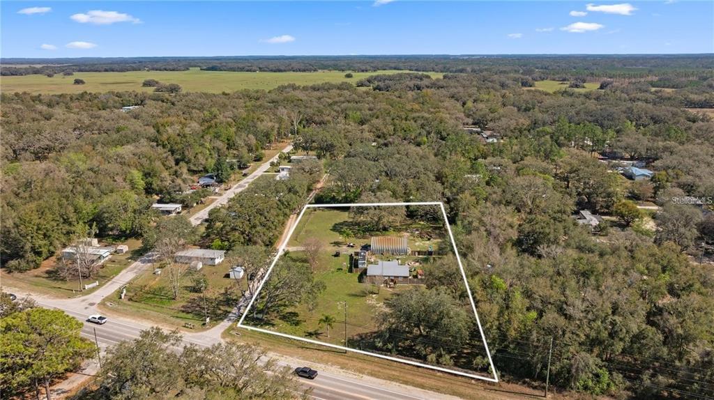 Undisclosed Address Spring Hill, FL 34610 - Photo 1 of 3 an aerial view of residential houses with outdoor space
