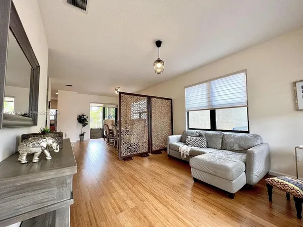a bedroom with furniture and wooden floor