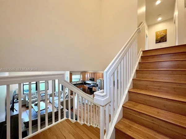 a view of entryway and hall with wooden floor
